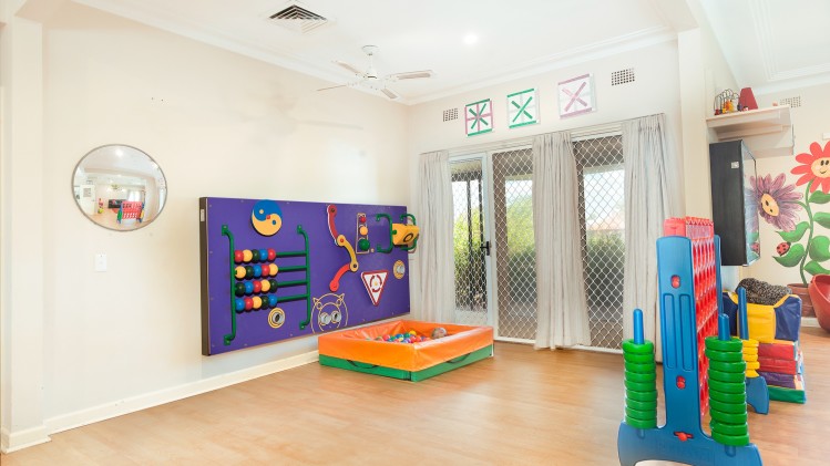 --Playroom with a play wall, small ball pit and life-size connect four game.--