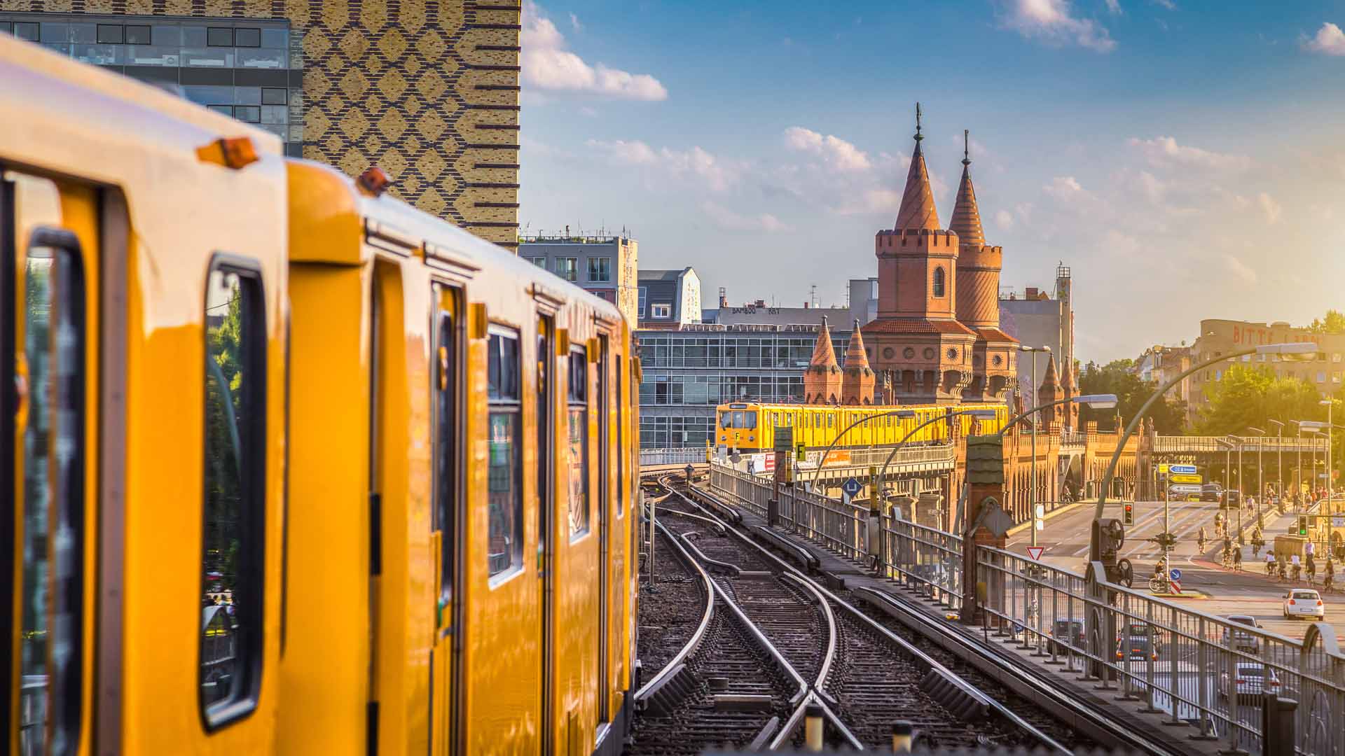 Panoramic view of Berliner U-Bahn with Oberbaum Bridge in the background in golden evening light at sunset with retro vintag