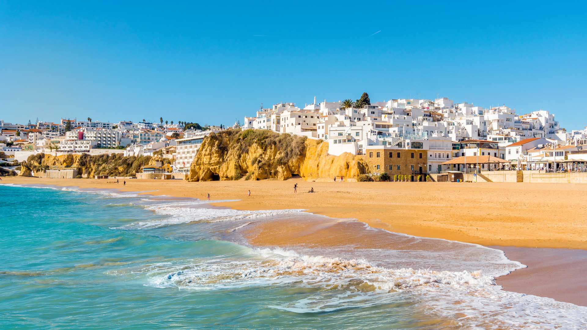 Wide-sandy-beach-in-white-city-of-Albufeira-Algarve-Portugal