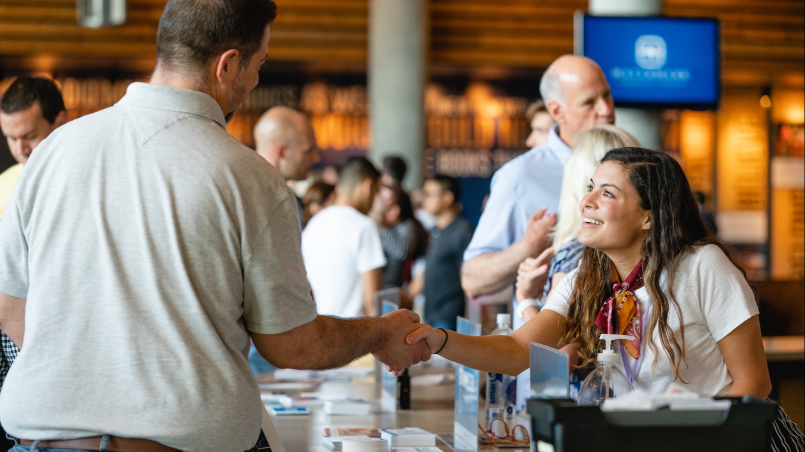 People interacting at the Welcome Center at Watermark Community Church Dallas campus.