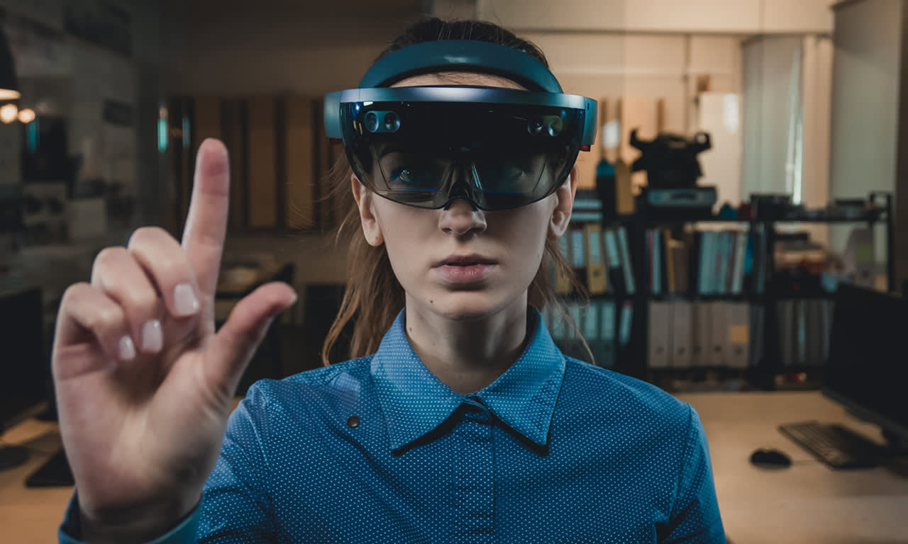 Woman wearing HoloLens using hand gesture