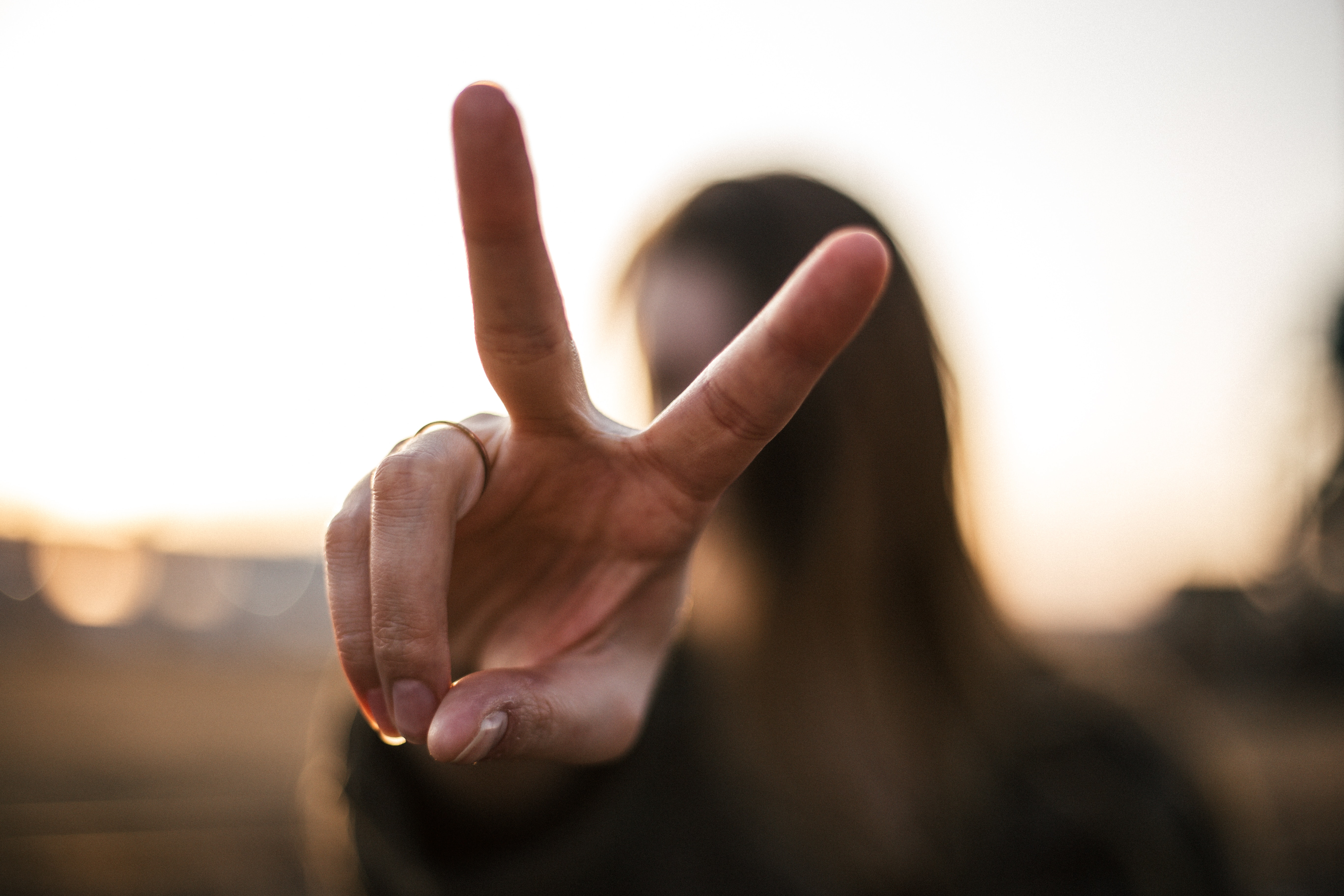 a hand making a peace sign