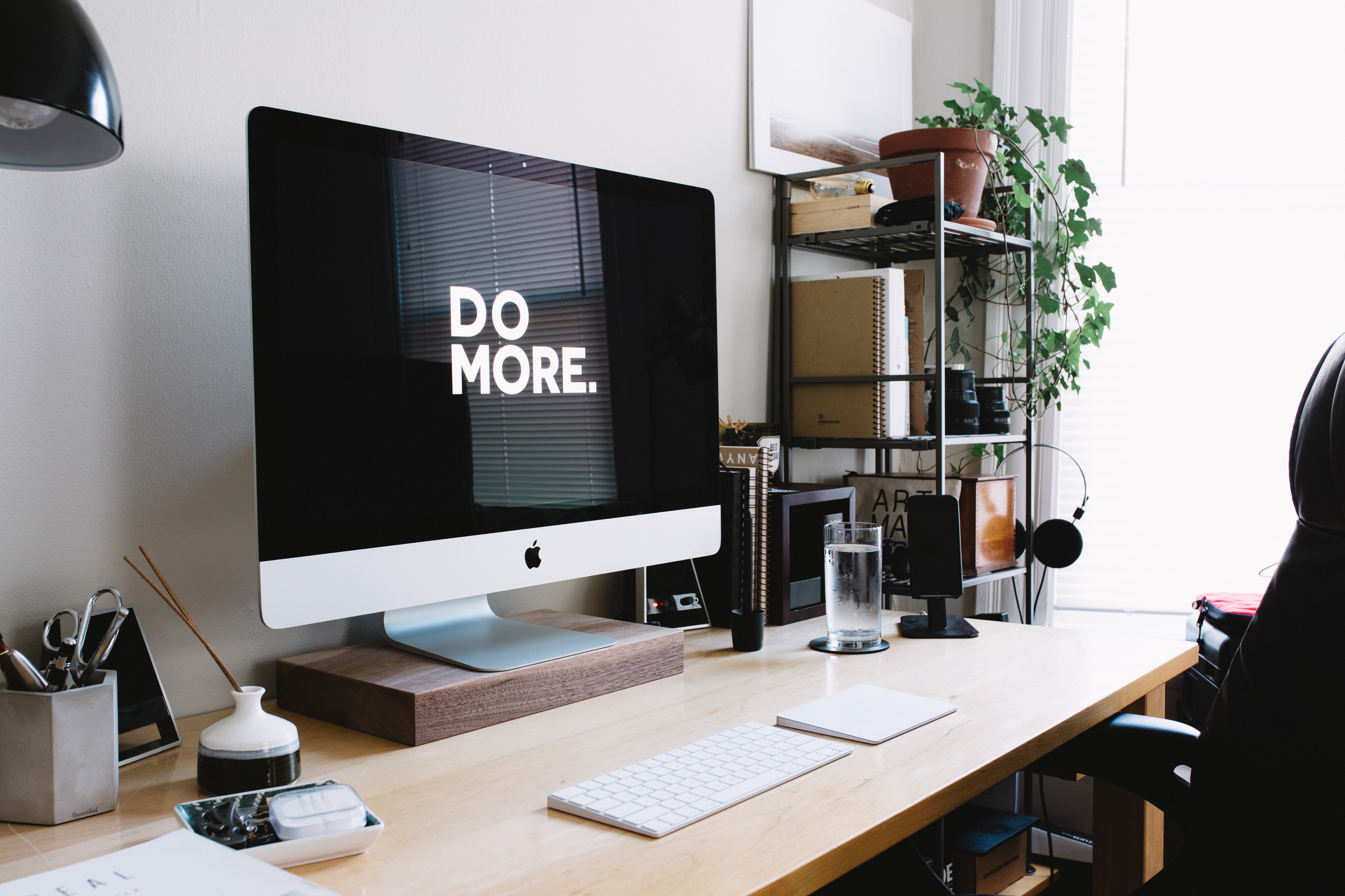photo of a desk in a study with a computer on it and the words "do more"