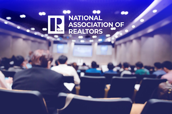 National Association of Realtors logo and a blurred conference room