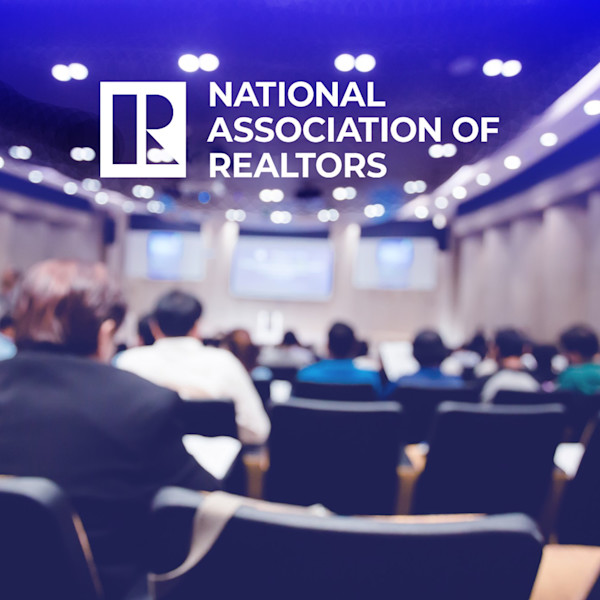 National Association of Realtors logo and a blurred conference room
