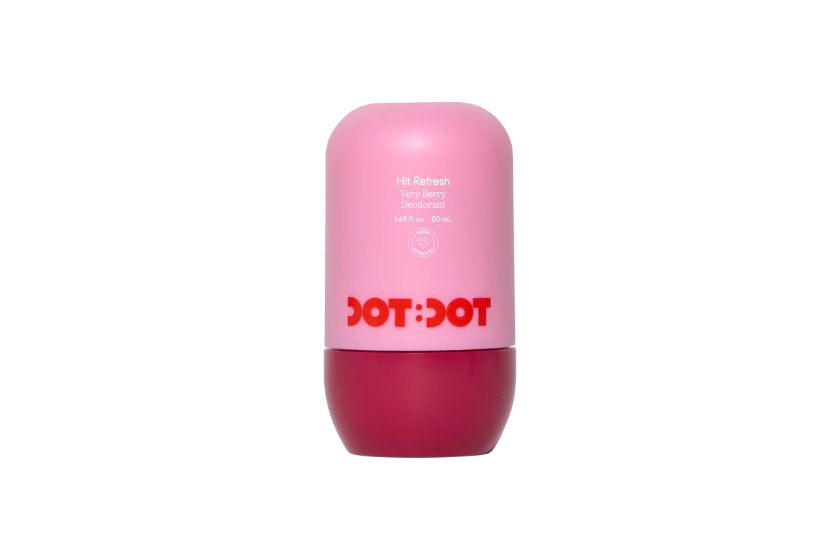 Dot:Dot Hit Refresh Very Berry Deodorant in a pink roll-on bottle with a dark berry-colored base and red logo.