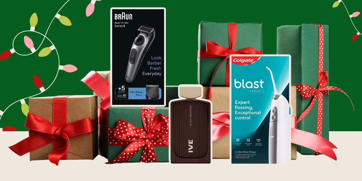Christmas gifts wrapped in green paper with red ribbons alongside grooming products including a Braun trimmer and Colgate floss