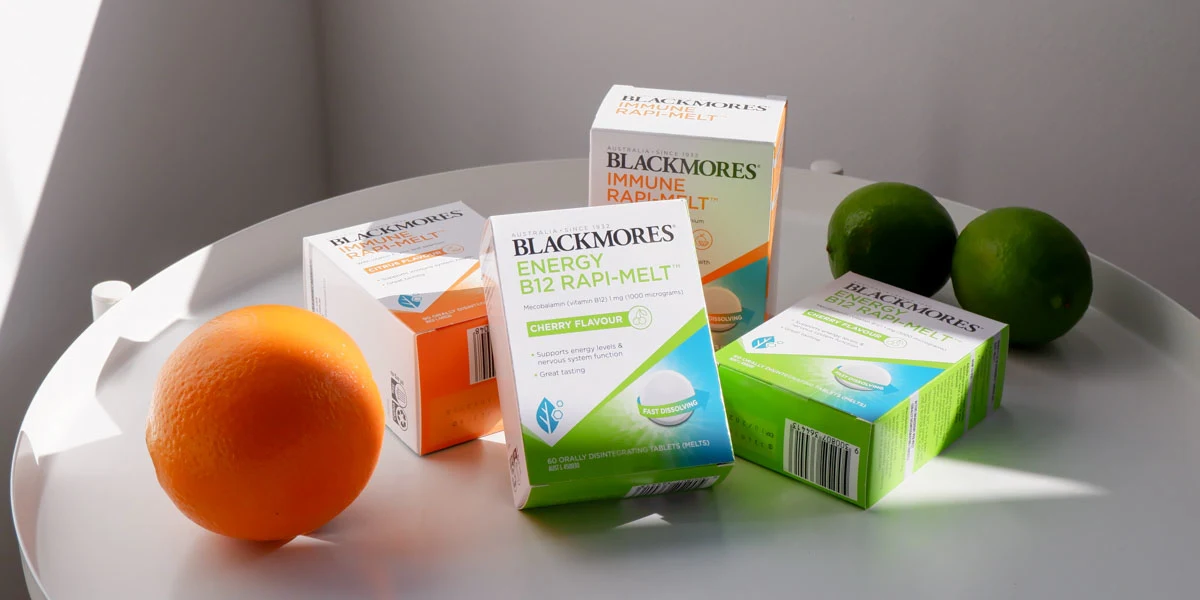 Blackmores Immune Rapi-Melts and Energy B12 Rapi-Melts on a white table with fruit