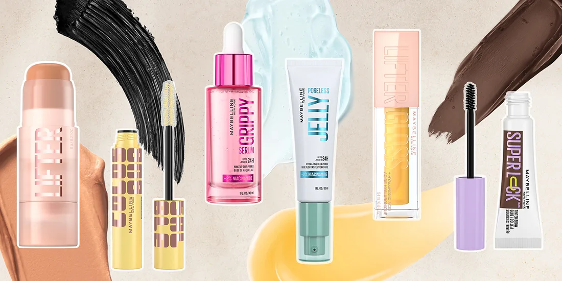 Collection of Maybelline makeup products including mascara wand, serums, and concealers with black and peach brush strokes in background.