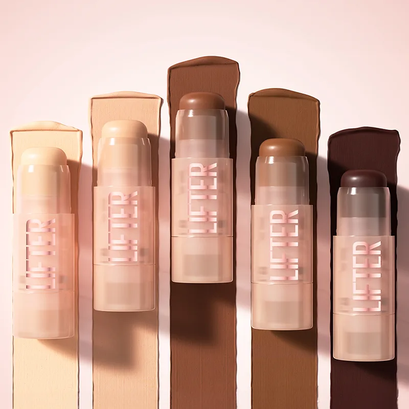 Row of lip balm or lipstick tubes in various nude and brown shades casting shadows on pink background.