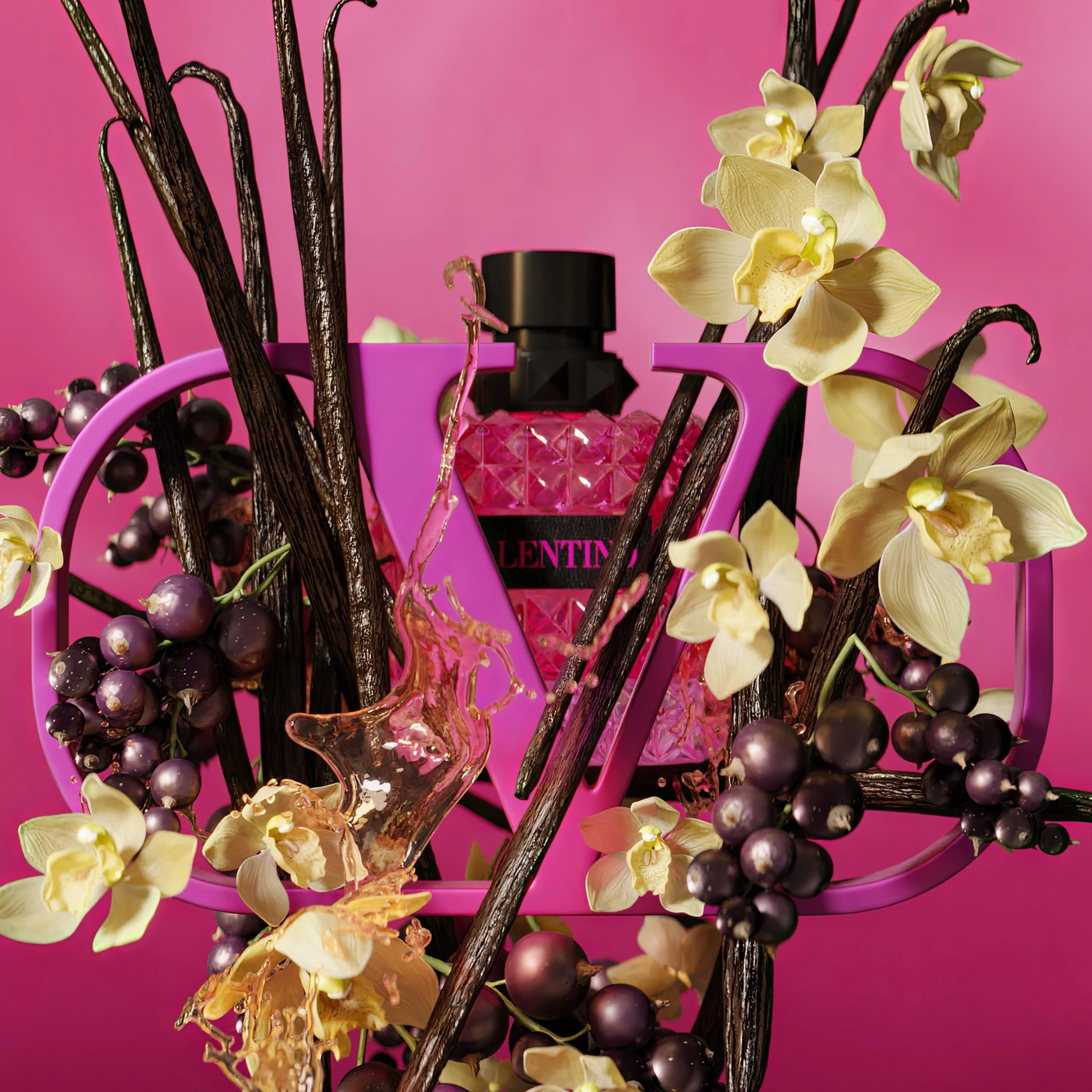 Valentino perfume bottle with dark branches, cream orchids, and purple grapes against vibrant pink background in artistic product photography