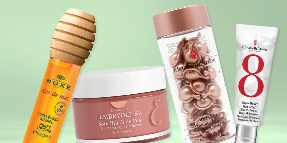 Beauty products on mint green background: Nuxe honey lip care, Embryolisse face cream, and Elizabeth Arden skincare items