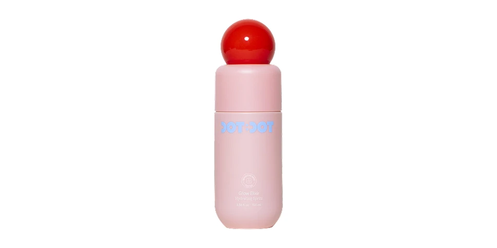Pink Dot Dot Glow Elixir Illuminating Spray bottle with a red spherical cap and blue text on white background.