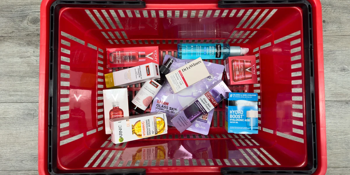 A red shopping basket filled with various skincare products including Vichy, Garnier, Neutrogena, and L'Oreal brands.