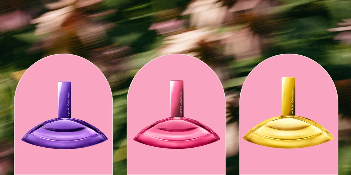Three Calvin Klein Euphoria perfume bottles in purple, pink, and yellow, displayed on pink arch backgrounds with a blurred garden backdrop.