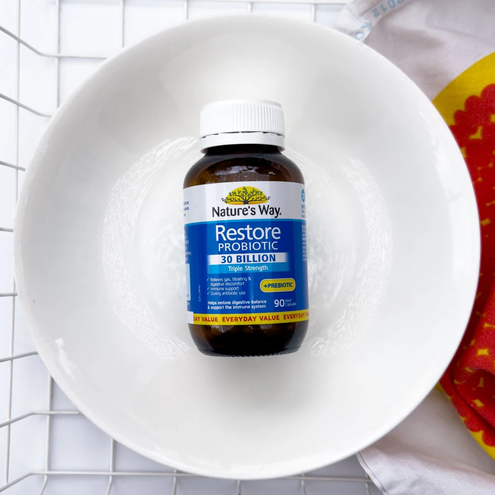Nature's Way Restore Probiotic in a white bowl