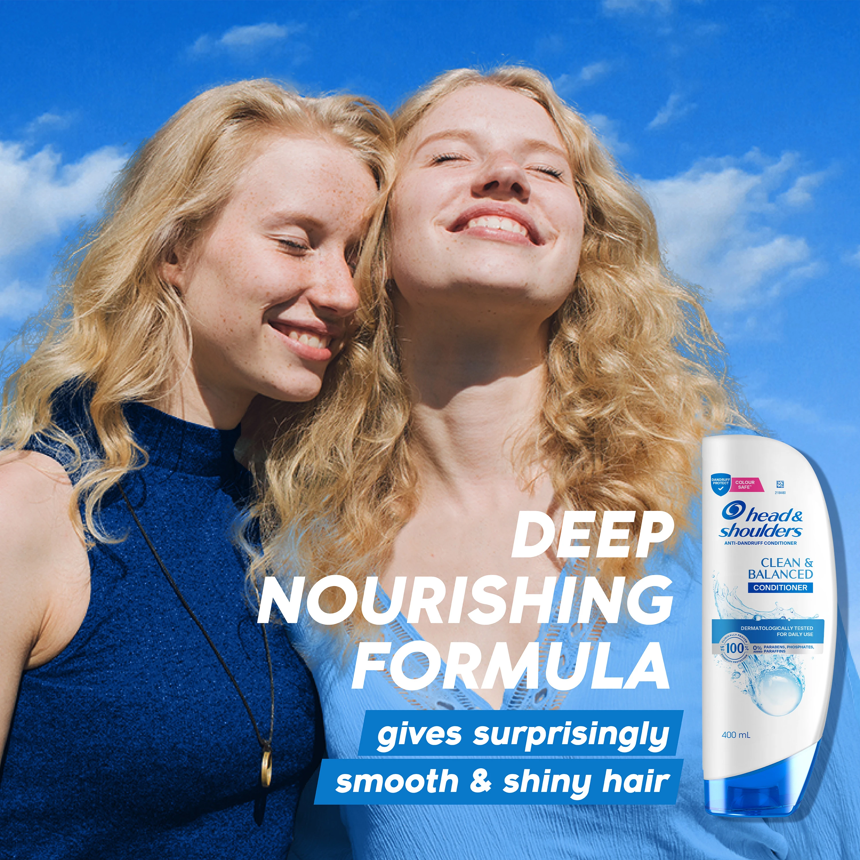 Hand holding Head & Shoulders Clean & Balanced conditioner bottle in shower with white tiled background
