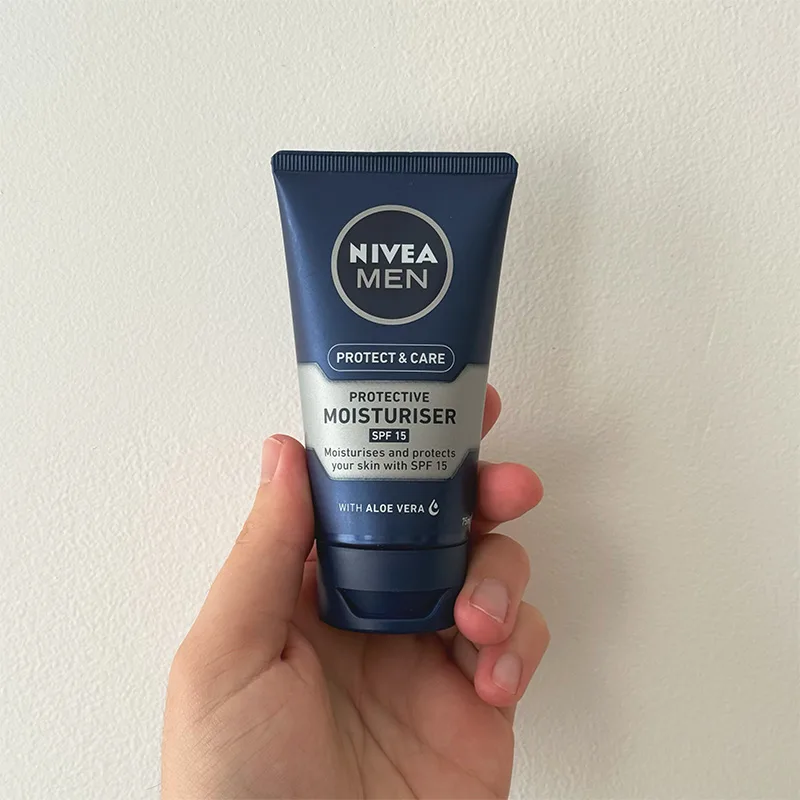 Hand holding a Nivea Men moisturiser