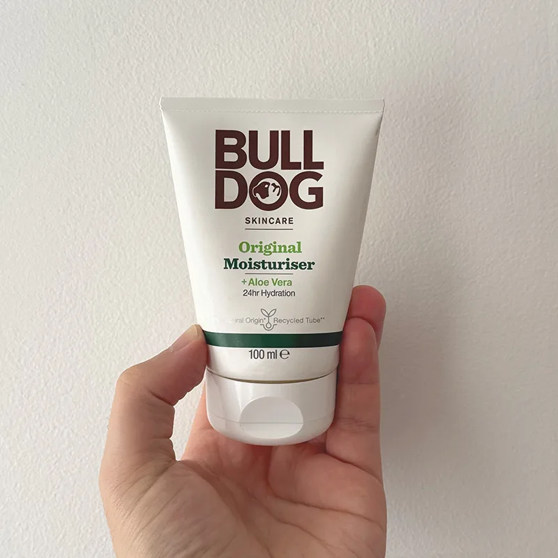 Hand holding a Bull Dog Original Facial Scrub product