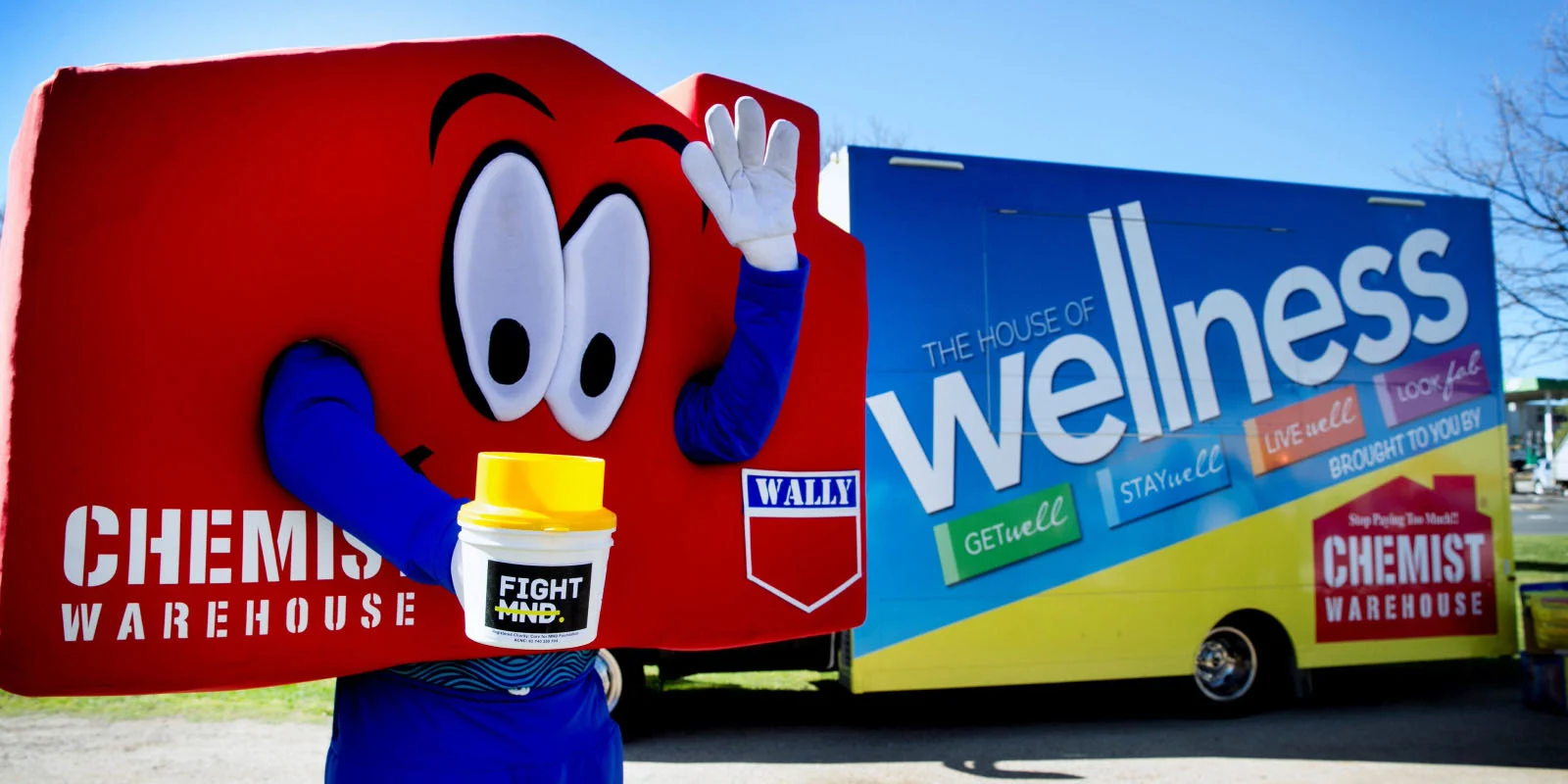 Chemist Warehouse mascot in-front of a The House of Wellness truck