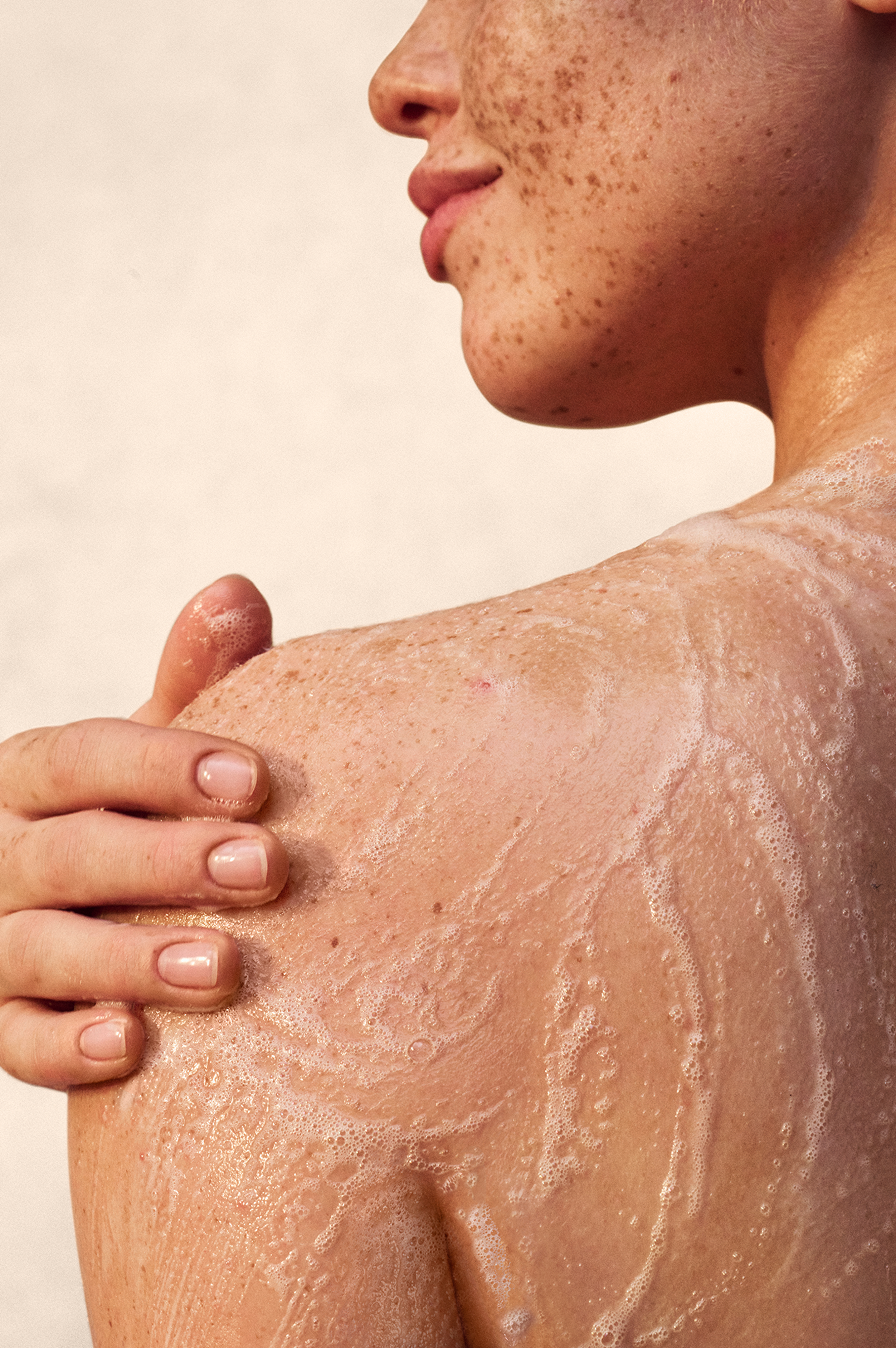 Man rubbing cream into his shoulder