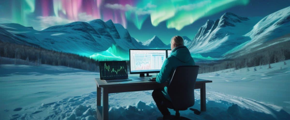 Range trading: A man at a desk with a computer screen showing range trading and aurora lights in the background. 