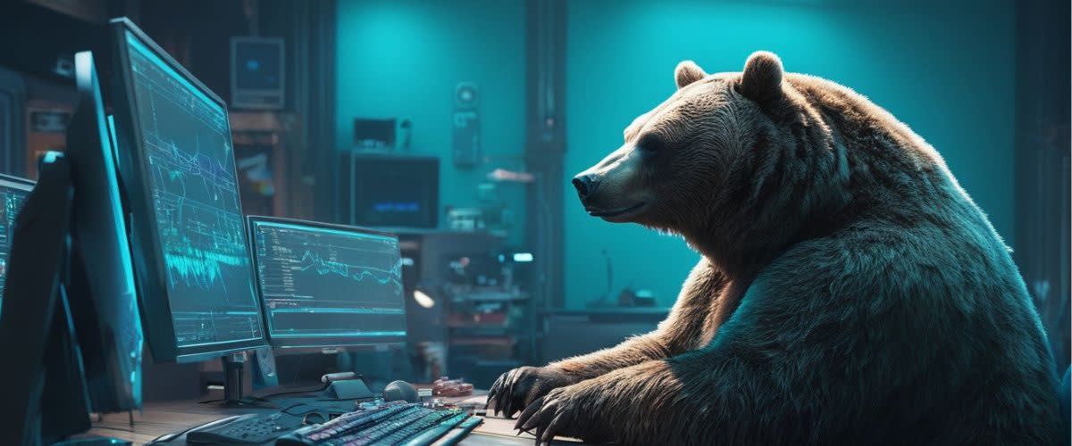 แนวโน้มภาวะหมี: หมีบนโต๊ะพร้อมหน้าจอคอมพิวเตอร์ แสดงถึงความเชื่อมั่นของตลาดหมี