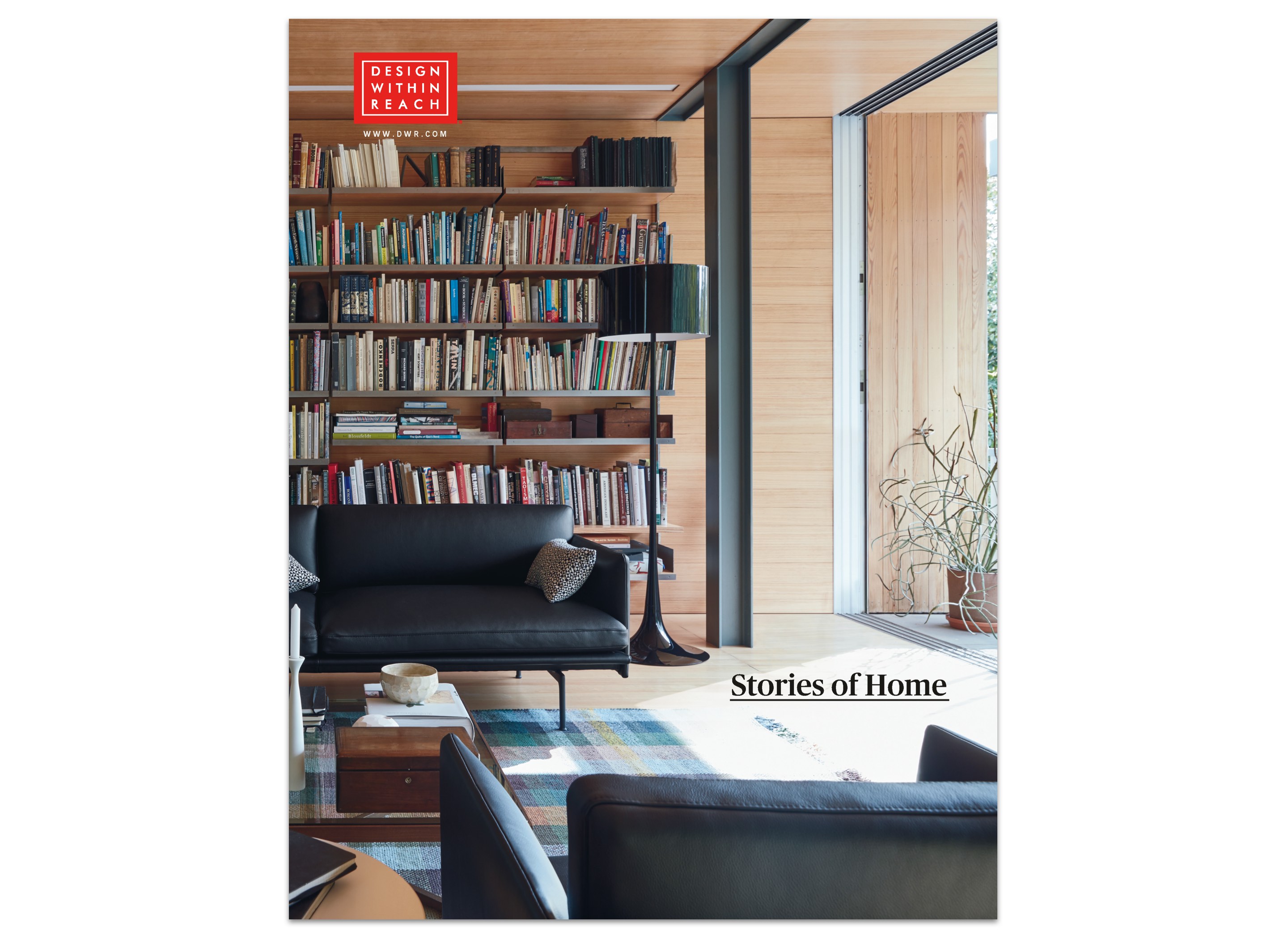 DWR catalog cover featuring a room with leather sofa and chair, bookcase filled with books, and area rug and editorial headline style