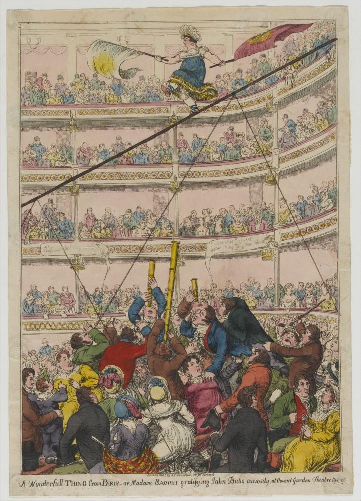 woman on a tightrope above a large crowd in theatre