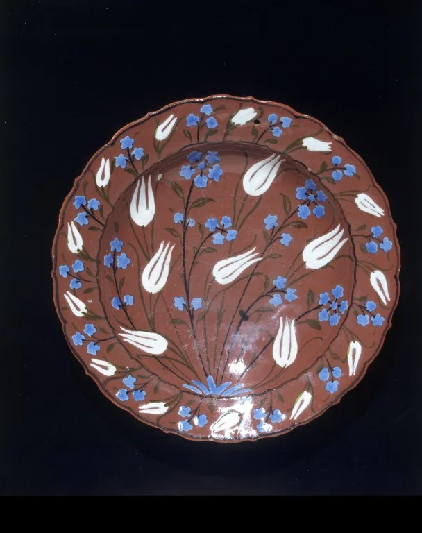 colour photograph, a brown dish with white and blue tulip motifs