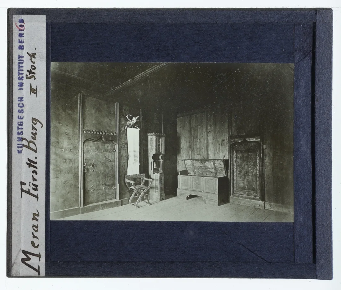 black and white slide of an interior room with wood panelled walls and a number of items of furniture