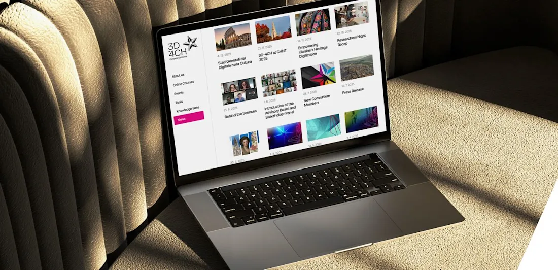 A laptop on a beige couch displays a website with various colorful thumbnails and menu options.