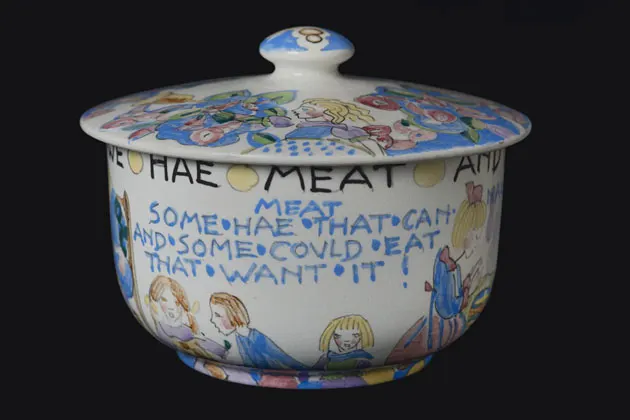 colour photograph of a ceramic bowl with illustration featuring text and people