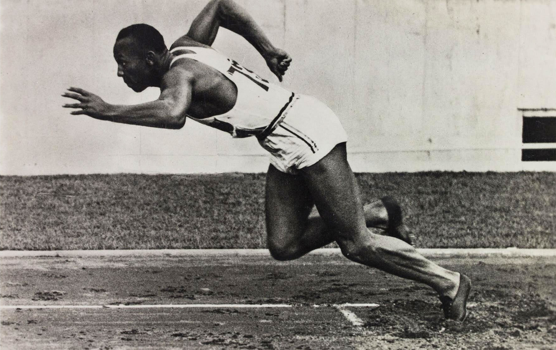 black and white photograph of Jesse Owens running.