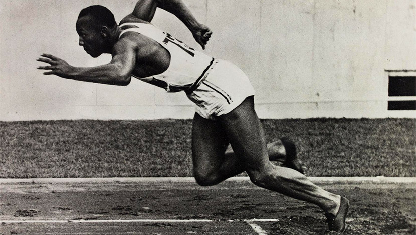 Strong athletic black skin woman sprinter, running on background