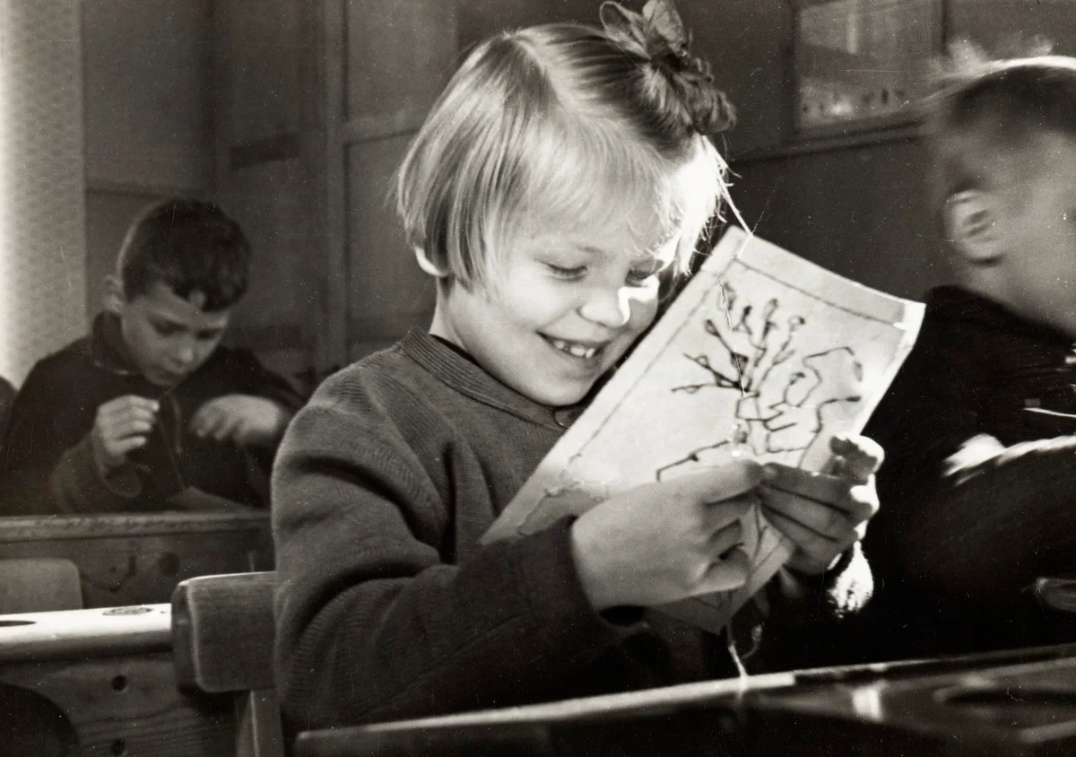 A girl embroidering on a paper at school in 1946.