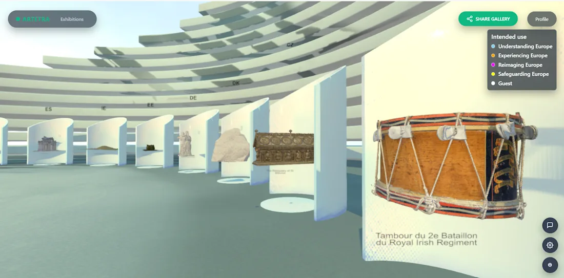 Virtual exhibit with artifacts on display in curved room, featuring a large drum in the foreground.