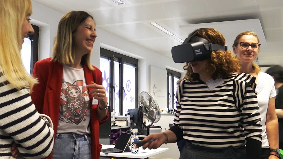 Exploring VR at the Europeana Workshop - a participant wears VR glasses while others look on. 