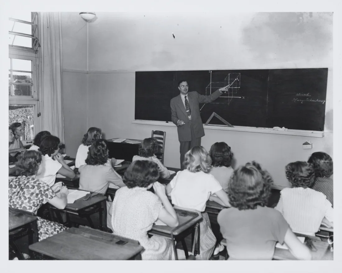 black and white photograph of Max Euwe in a classroom