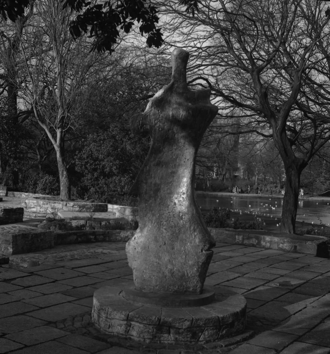 black and white photograph of a sculpture in a park
