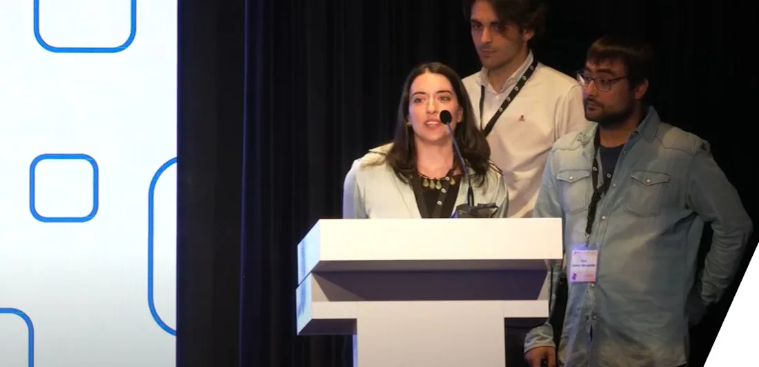 Three young professionals presenting in front of a podium