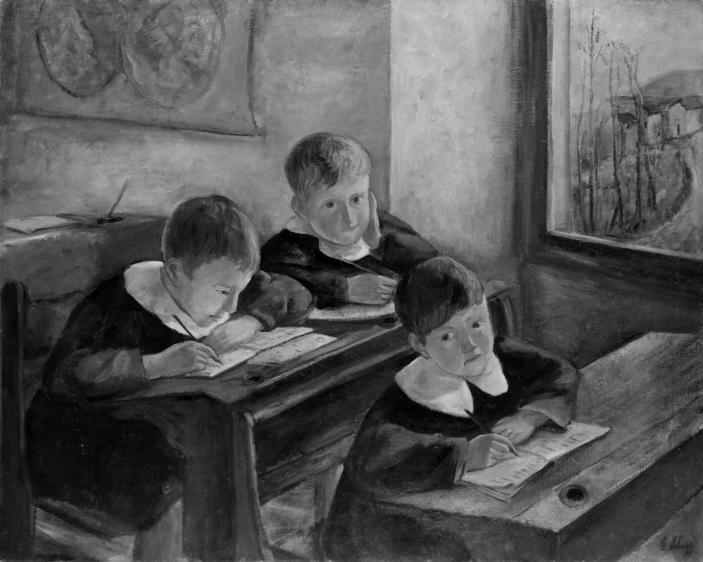 Three young children in old-fashioned clothing sit at wooden desks, writing or reading near a window in a classroom.