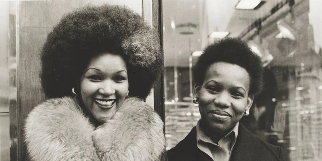 Two women smile for a photograph