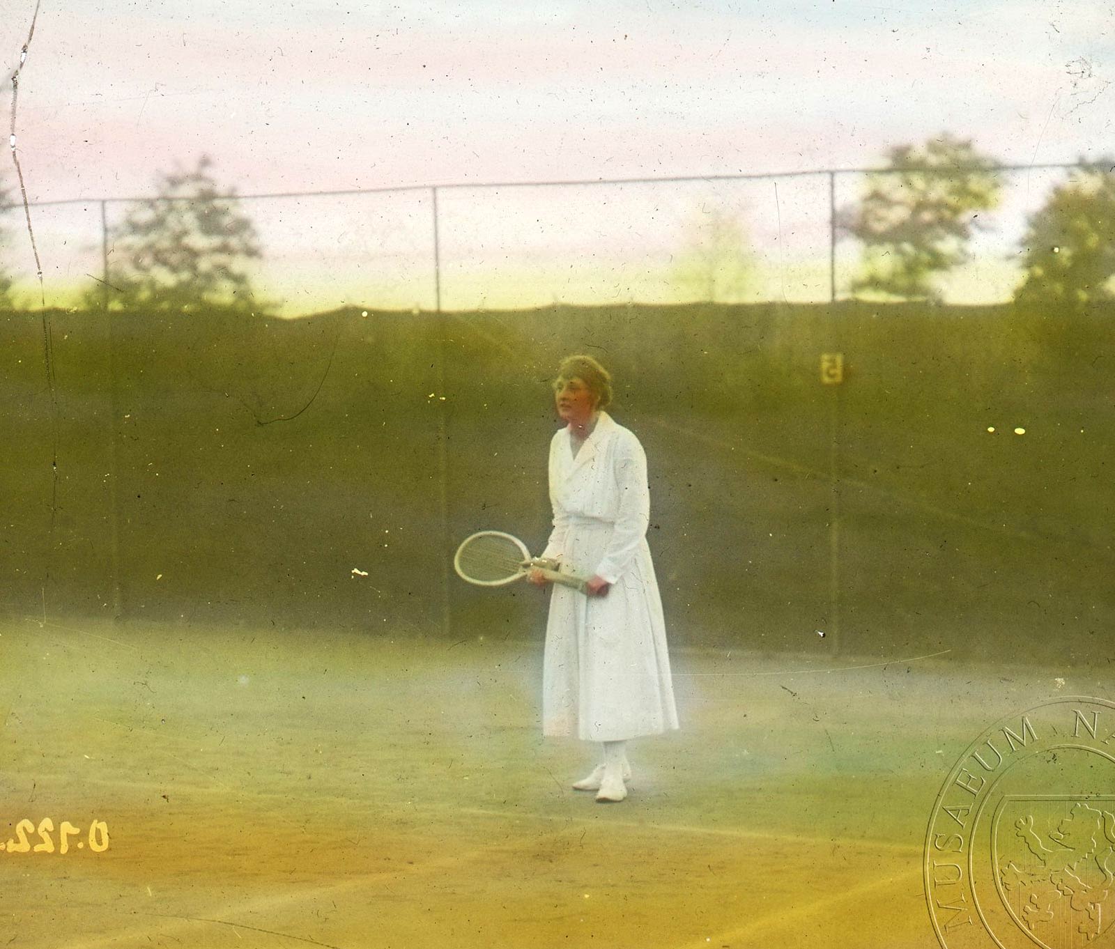 colour photograph of Kathleen McKane holding a tennis racket.