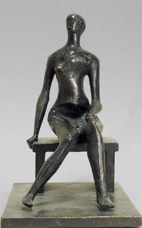 photograph of a bronze sculpture of an abstract seated figure