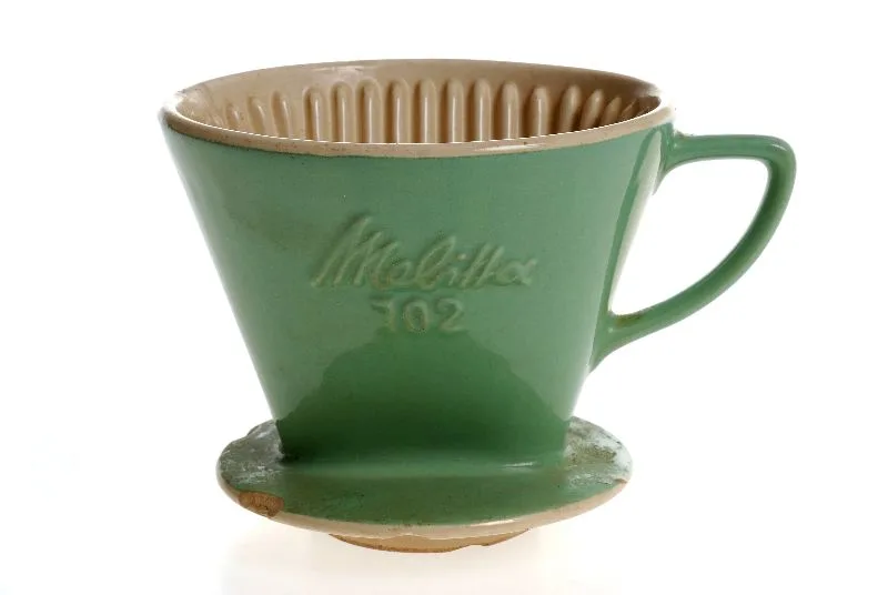 colour photograph of a green ceramic coffee filter