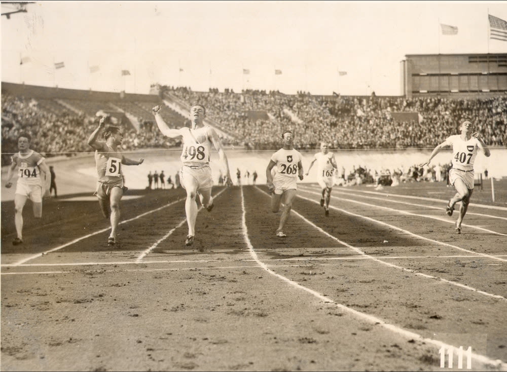 black and white photograph, male athletes running a race in the 1928 Amsterdam Olympic stadium