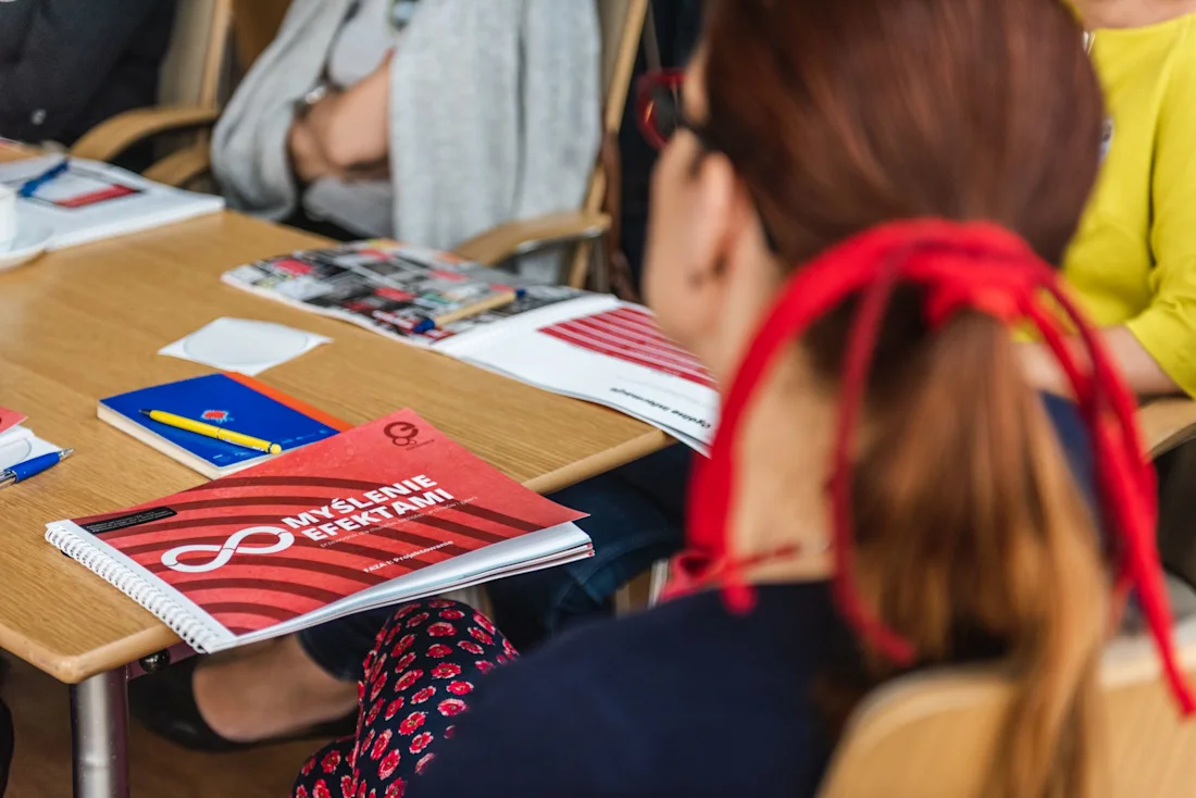 A woman seen from behind looking at the Europeana Impact Playbook