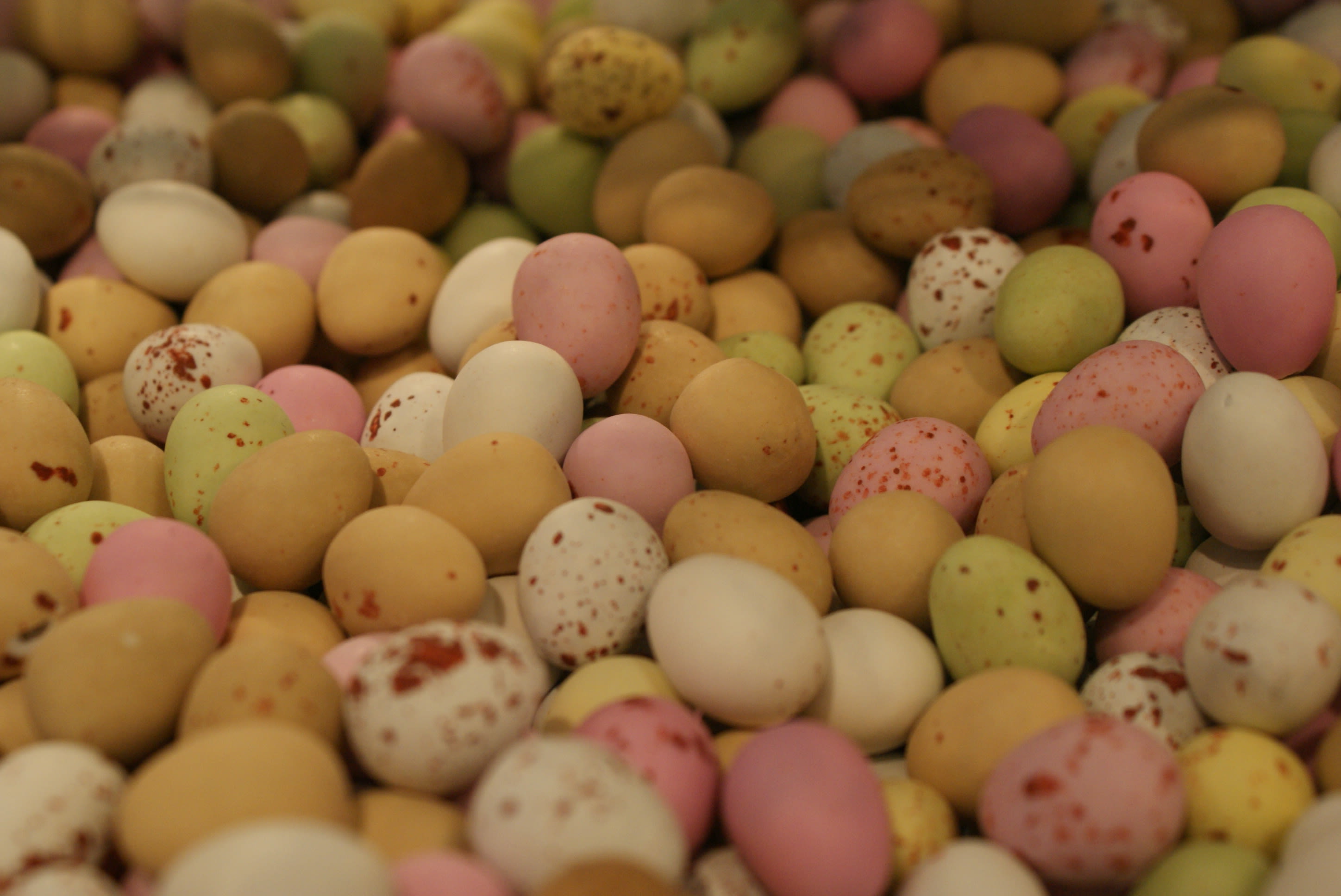 a pile of differently coloured and speckled candy eggs stretches into the background