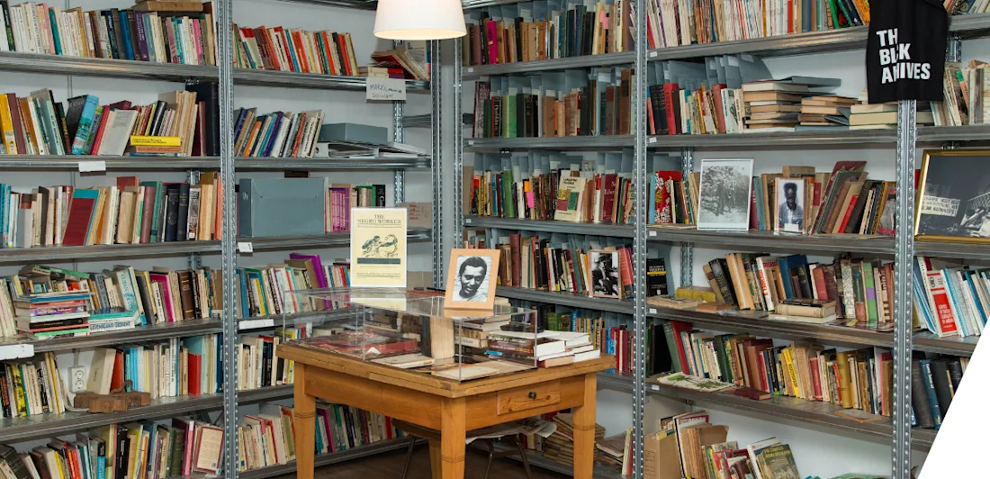Bookshelves and a table in the Black Archives